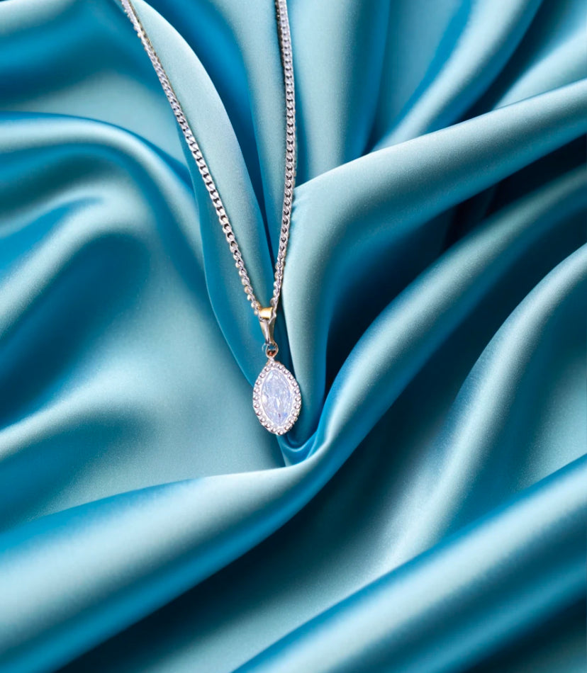 silver marquise zirconia stone pendant on blue silk background