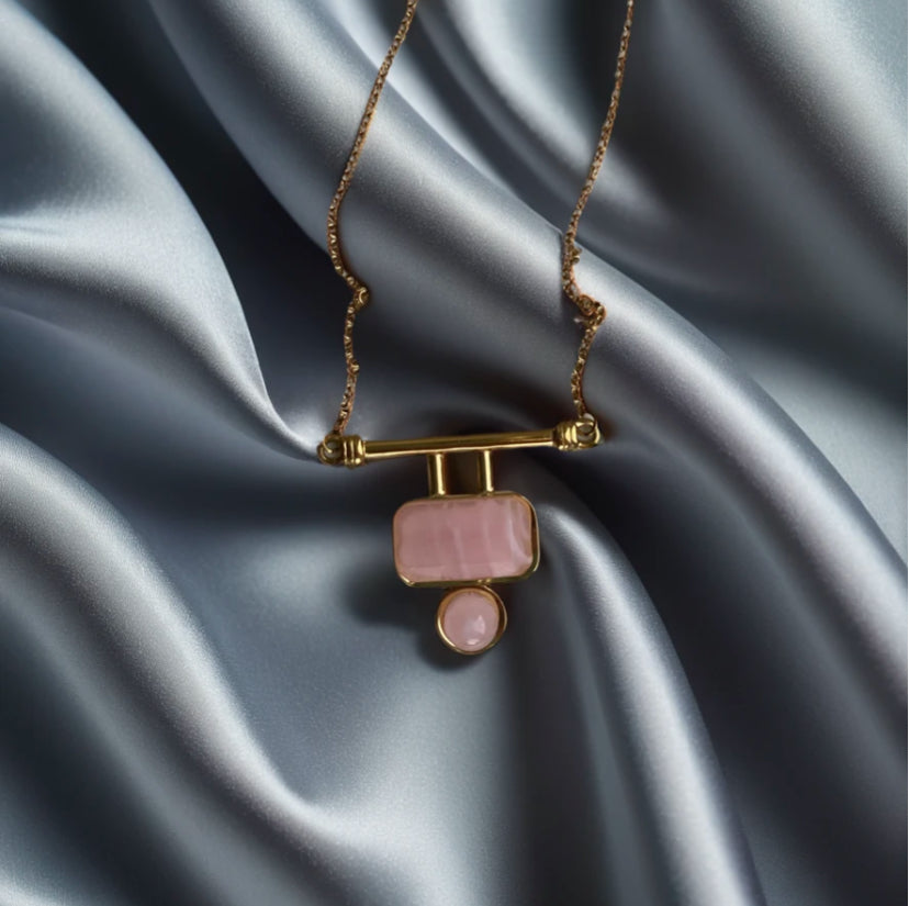 pink pendant necklace on silk background