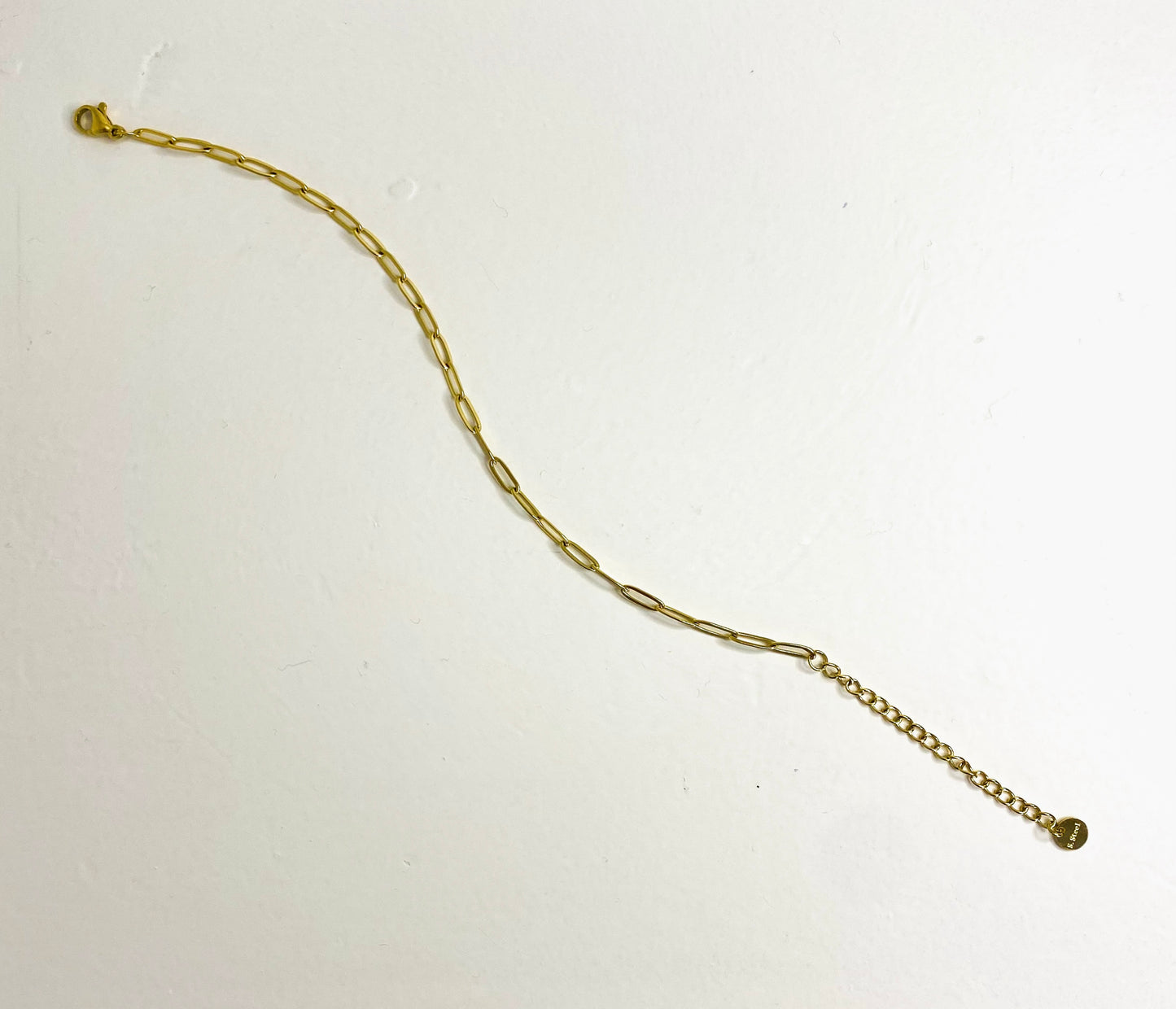 gold plated chain bracelet on plain white background