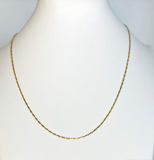 gold plated fine necklace on a white manakin 